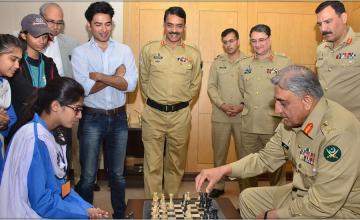 Students play chess with COAS Bajwa