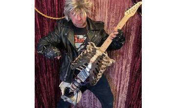Man builds guitar out of his dead uncle’s skeleton, uses it to play black metal