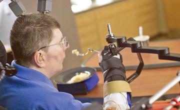 Paralysed man is able to feed himself for the first time in 30 years thanks to robotic arms