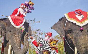 IN THAILAND, SANTA DELIVERS PRESENTS ON ELEPHANTS