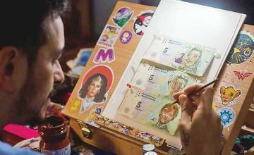 ARGENTINE ARTIST PAINTS ON INFLATION-HIT BANK NOTES
