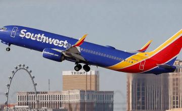 PASSENGER USES SOUTHWEST AIRLINES PLANE'S EMERGENCY EXIT AND CLIMBS ON WING IN NEW ORLEANS